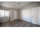 This bedroom has wood-look floors and a white ceiling fan at 2725 S Nellis Blvd # 2045, Las Vegas, NV 89121