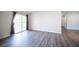 Spacious bedroom with sliding glass door access, gray wood flooring and neutral gray walls at 2725 S Nellis Blvd # 2045, Las Vegas, NV 89121