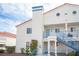 Exterior view of a two story condo with blue accents, a red tile roof, and desert landscaping at 2725 S Nellis Blvd # 2045, Las Vegas, NV 89121
