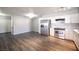 View of the kitchen with stainless steel appliances, white cabinetry and hardwood floors at 2725 S Nellis Blvd # 2045, Las Vegas, NV 89121