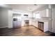 View of the kitchen with stainless steel appliances, white cabinetry and hardwood floors at 2725 S Nellis Blvd # 2045, Las Vegas, NV 89121