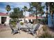 Outdoor seating area with a table and chairs surrounded by desert landscaping and palm trees at 2725 S Nellis Blvd # 2045, Las Vegas, NV 89121