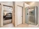 Ensuite bathroom featuring a glass shower and doorway into the primary bedroom at 28 Birkdale Dr, Henderson, NV 89074