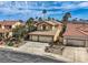 Two-story home with a three-car garage and desert landscaping at 28 Birkdale Dr, Henderson, NV 89074