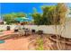 Picturesque backyard featuring a brick patio, dining area, and meticulously manicured landscaping at 280 Pear Meadow St, Henderson, NV 89012