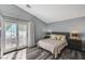 Charming bedroom with wood-look floors, a patio door to an outdoor seating area, and stylish furnishings at 280 Pear Meadow St, Henderson, NV 89012