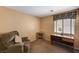 Inviting bedroom featuring a comfortable chair, desk, and a well-lit workspace at 280 Pear Meadow St, Henderson, NV 89012