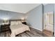 This bedroom includes wood-look floors, a walk-in closet, and modern decor at 280 Pear Meadow St, Henderson, NV 89012