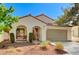 Inviting single-story home with desert landscaping, covered porch, and two car garage at 280 Pear Meadow St, Henderson, NV 89012