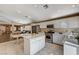 Bright kitchen features white cabinets, stainless steel appliances, and an island, seamlessly open to the living area at 280 Pear Meadow St, Henderson, NV 89012