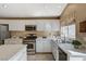 This kitchen boasts white cabinets, stainless steel appliances, and a window offering natural light at 280 Pear Meadow St, Henderson, NV 89012