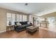 Open living area showcasing a comfortable couch, large windows, and connection to the kitchen at 280 Pear Meadow St, Henderson, NV 89012