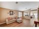 Open living room with wood tile flooring, large windows, and neutral decor at 280 Pear Meadow St, Henderson, NV 89012