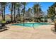 Sparkling community pool with lounge chairs, lush landscaping, and shade structures at 280 Pear Meadow St, Henderson, NV 89012