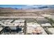 The aerial shot showcases commercial buildings and parking areas against a backdrop of mountains at 320 Lorelei Rock St, Las Vegas, NV 89138