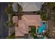 Overhead shot displaying the home layout, tile roof, outdoor entertaining area, and refreshing swimming pool at 320 Lorelei Rock St, Las Vegas, NV 89138