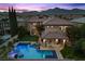 Stunning aerial view of the home showcasing the backyard pool, patio, landscaping, and mountain views at 320 Lorelei Rock St, Las Vegas, NV 89138