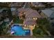 Elevated view of the home highlighting the outdoor space, pool, spa, patio area, and the well-maintained landscaping at 320 Lorelei Rock St, Las Vegas, NV 89138