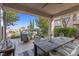 Inviting covered back patio with comfortable seating and a view of the sparkling pool and landscaped backyard at 320 Lorelei Rock St, Las Vegas, NV 89138