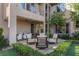 Backyard patio area with comfortable seating options and manicured hedges, perfect for outdoor living at 320 Lorelei Rock St, Las Vegas, NV 89138