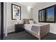 This bedroom features a wooden bed frame, an art print, and a window with black shutters at 320 Lorelei Rock St, Las Vegas, NV 89138