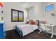 Cozy bedroom with a blue bed frame, a white desk, and plenty of natural light at 320 Lorelei Rock St, Las Vegas, NV 89138