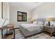 This bedroom features a stylish gray bed frame, bedside table, and a window with black shutters at 320 Lorelei Rock St, Las Vegas, NV 89138