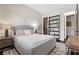This bedroom has a plush gray bed, a bookcase, and direct access to an ensuite bathroom at 320 Lorelei Rock St, Las Vegas, NV 89138