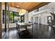 Dining room showcasing a large table, modern light fixture, wood ceiling and large windows at 320 Lorelei Rock St, Las Vegas, NV 89138