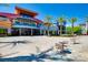 Exterior view of a public school with modern architecture, complemented by palm trees and outdoor seating areas at 320 Lorelei Rock St, Las Vegas, NV 89138
