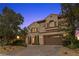 Elegant two-story home with a three-car garage and a paved driveway at 320 Lorelei Rock St, Las Vegas, NV 89138