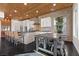 Modern kitchen featuring stone accents, stainless steel appliances, island seating and light wood plank ceiling at 320 Lorelei Rock St, Las Vegas, NV 89138