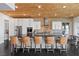Spacious kitchen featuring modern appliances, island seating, stone backsplash and wood ceiling at 320 Lorelei Rock St, Las Vegas, NV 89138