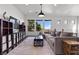 Living room featuring an area rug, large sofa, modern light fixture, and scenic windows at 320 Lorelei Rock St, Las Vegas, NV 89138
