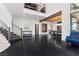Open-concept living space with dark hardwood flooring and a cozy blue armchair at 320 Lorelei Rock St, Las Vegas, NV 89138