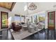 Sun-filled living area showcases tall windows, dark floors and comfortable seating arrangements at 320 Lorelei Rock St, Las Vegas, NV 89138