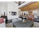 Cozy living room with built-in cabinets, TV, and an adjacent modern kitchen at 320 Lorelei Rock St, Las Vegas, NV 89138