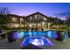 Inviting backyard pool and spa with covered patio, perfect for relaxing evenings and outdoor entertaining at 320 Lorelei Rock St, Las Vegas, NV 89138