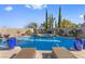 Resort-style pool and spa surrounded by lush landscaping and patio furniture at 320 Lorelei Rock St, Las Vegas, NV 89138