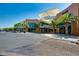 Street-level view shows retail storefronts with lush landscaping and palm trees, highlighting a desirable commercial space at 320 Lorelei Rock St, Las Vegas, NV 89138