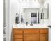 Bathroom featuring a wood vanity, large mirror, and modern sink at 3221 Yolanda Ln, Las Vegas, NV 89121
