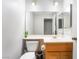 Cozy half bath featuring wood vanity, neutral walls, and modern lighting at 3221 Yolanda Ln, Las Vegas, NV 89121