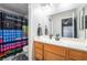 Bathroom featuring a wood vanity, large mirror, and periodic table shower curtain at 3221 Yolanda Ln, Las Vegas, NV 89121