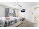 Bright bedroom with mounted TV, carpet, and ceiling fan, window with curtains at 3221 Yolanda Ln, Las Vegas, NV 89121
