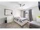 Bright bedroom featuring bed, mirror, window with curtains, carpet floor, ceiling fan and a small ottoman at 3221 Yolanda Ln, Las Vegas, NV 89121