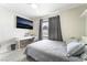 Relaxing bedroom featuring a bed, a desk and a mounted television at 3221 Yolanda Ln, Las Vegas, NV 89121