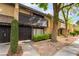 Multi-level townhouse featuring mature landscaping and dark wood accents at 3221 Yolanda Ln, Las Vegas, NV 89121