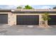 Attached garage parking featuring black garage doors on a condo at 3221 Yolanda Ln, Las Vegas, NV 89121