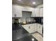 Stylish kitchen boasting modern white cabinets, sleek black countertops, and contemporary fixtures at 3221 Yolanda Ln, Las Vegas, NV 89121