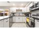 Modern kitchen with white cabinets, stainless steel appliances, and black countertops at 3221 Yolanda Ln, Las Vegas, NV 89121